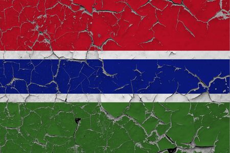 Gambia flag close up grungy, damaged and scratched on wall peeling off paint to see inside surface. Vintage National Concept.の写真素材