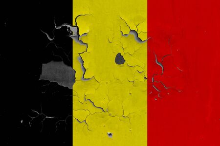 Belgium flag close up old, damaged and dirty on wall peeling off paint to see inside surface. Vintage National Concept.の写真素材
