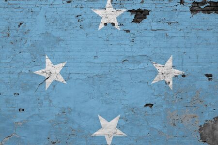 Micronesia flag on grunge scratched concrete surface. National vintage background. Retro wall concept.の写真素材