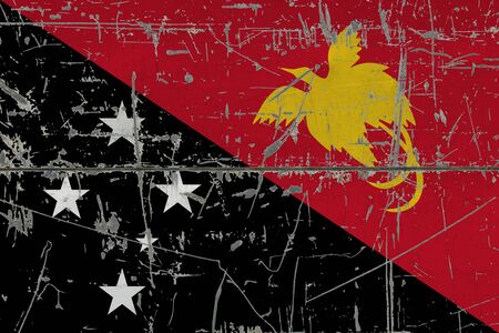 Papua New Guinea flag painted on cracked dirty surface. National pattern on vintage style surface. Scratched and weathered concept.の写真素材