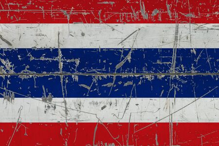Thailand flag painted on cracked dirty surface. National pattern on vintage style surface. Scratched and weathered concept.の写真素材