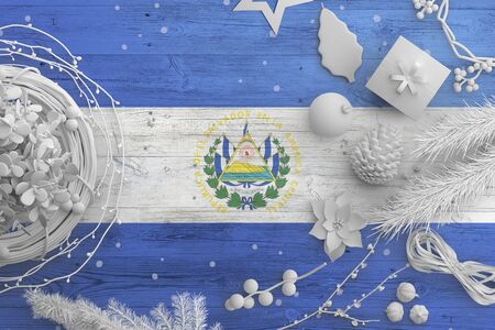 El Salvador flag on wooden table with snow objects. Christmas and new year background, celebration national concept with white decor.の写真素材