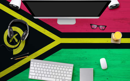 Vanuatu flag background with headphone,computer keyboard and mouse on national office desk table.Top view with copy space.Flat Lay.の写真素材