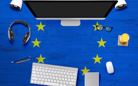 European Union flag background with headphone,computer keyboard and mouse on national office desk table.Top view with copy space.Flat Lay.の写真素材