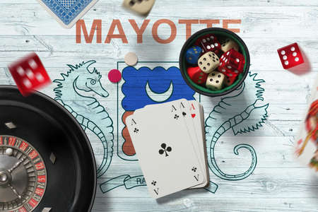 Mayotte casino theme. Aces in poker game, cards and chips on red table with national flag...