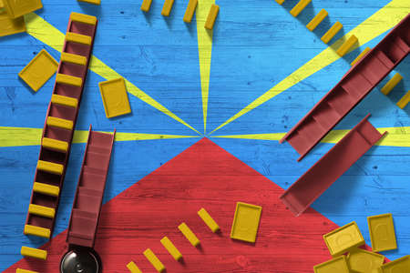 Reunion flag with national background with dominoes on wooden table. Top view. Concept of game.の写真素材