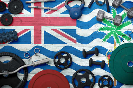 British Indian Ocean Territory sports and fitness concept. Top view of heavy weight plates with iron bar on national background.の写真素材