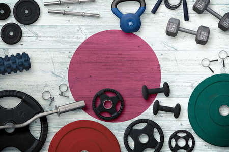 Japan sports and fitness concept. Top view of heavy weight plates with iron bar on national...