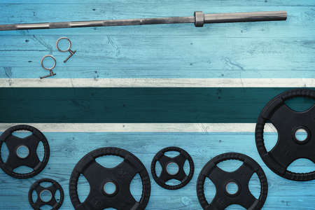 Botswana gym concept. Top view of heavy weight plates with iron bar on national background.の写真素材