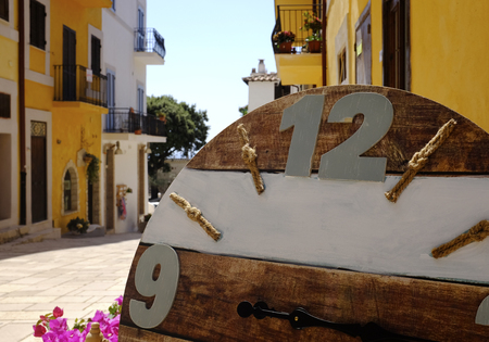 Wooden clock in the foreground at a stall of a store. Taken in San Felice Circeo, a typical seaside...