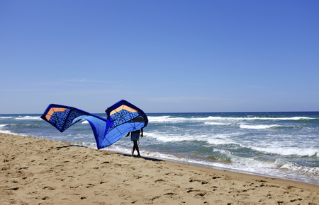 Man surfer in wetsuits with kite equipment for surfing, in Sabaudia, Lazio, Italyの写真素材