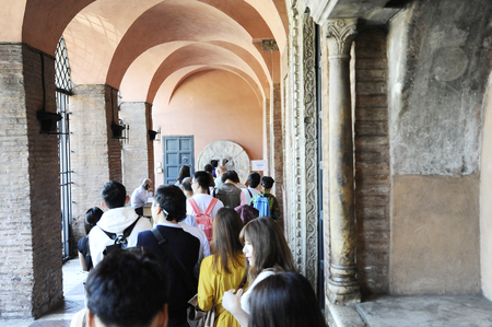 Rome, Italy â October 10, 2018: Visitors waiting to see the mouth of truth (Bocca della VeritÃ ). It attracts visitors who audaciously stick their hand in the mouth. Church of Santa Maria in Cosmedin in Rome, Italyのeditorial素材
