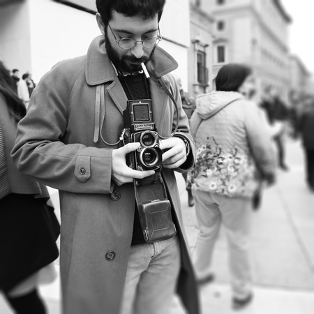 Bologna, Italy ? ?? November 05, 2018: Close-up of Hipster man with the vintage Rolleiflex camera. Photographer with a famous retro camera. Bologna, Italyのeditorial素材