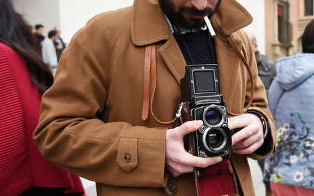Close-up of Hipster man with the vintage camera. Photographer with a famous retro camera. Bologna, Italyの写真素材
