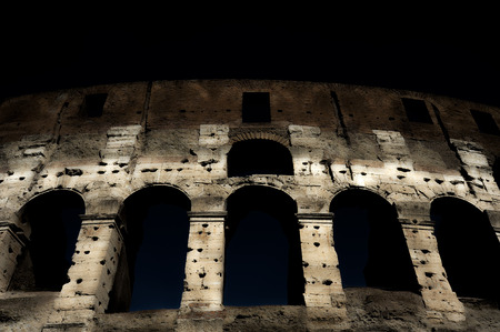 A section of the facade of the Colosseum (Flavian Amphitheatre) in Rome during the blue hour. Night view. Rome, Lazio, Italyの写真素材