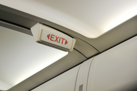 Close up of exit sign in passenger airplane.の写真素材