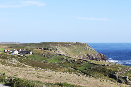Ocean view to the horizon at a green cliff in England's Land's End. Cornwall, UK