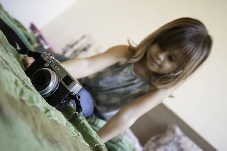 Indoor lifestyle portrait of cute little girl looking camera. Talented little girl has fun with...