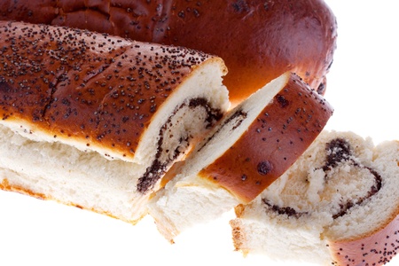 Sliced ââbread with poppy seeds on a white backgroundの写真素材