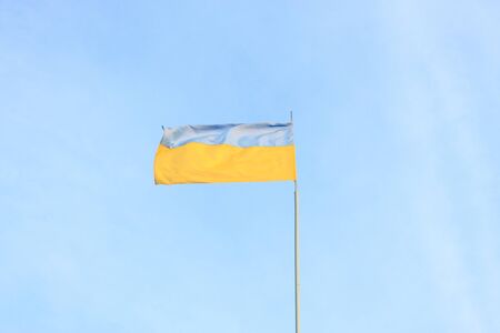 Ukrainian flag on a background of blue skyの写真素材