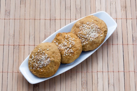 sweet cakes with sesame seeds on a plateの写真素材