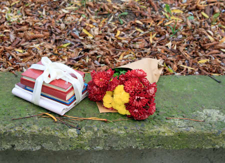 bouquet of chrysanthemums and a stack of booksの写真素材