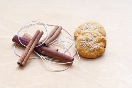 biscuits, cinnamon sticks and a cordの写真素材