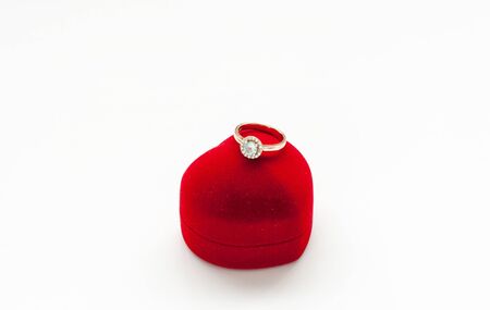 Gold ring with a diamond on the box in the form of heartの写真素材