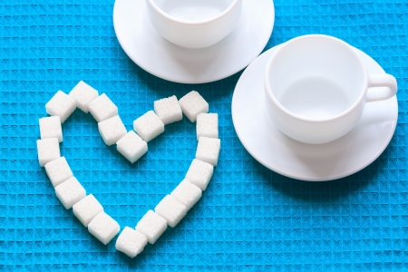 White Sugar in heart shape on blue napkinの写真素材