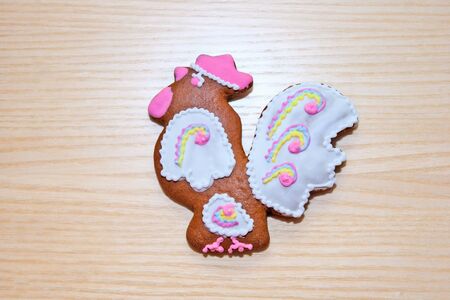 Gingerbread in the form of a bird on a wooden backgroundの写真素材