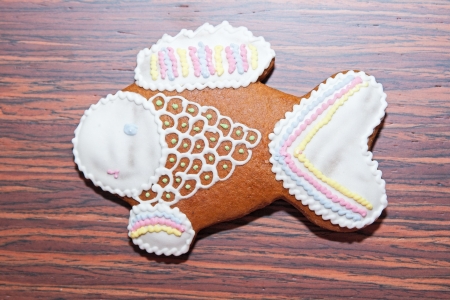 Gingerbread in the form of a fish on a wooden backgroundの写真素材
