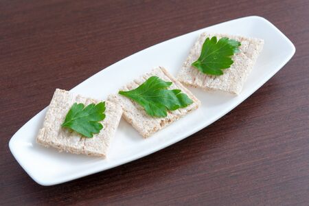 Diet bread with parsley on a plateの写真素材