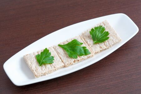 Diet bread with parsley on a plateの写真素材