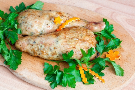 Fried chicken legs with parsley on the boardの写真素材