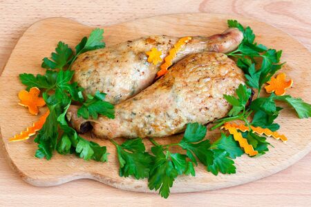 Fried chicken legs with parsley on the boardの写真素材