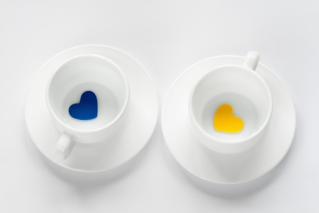 empty cup and saucer with hearts on whiteの写真素材