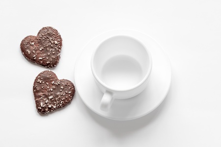 cup and saucer and a chocolate coconut cookiesの写真素材