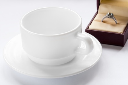 silver ring with a diamond and a cup and saucerの写真素材