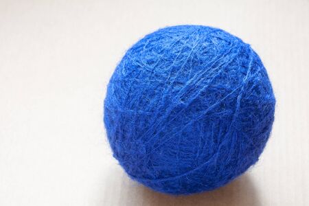 blue wool yarn skein on cardboard backgroundの写真素材