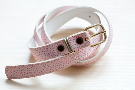 pink women style belt on a light wooden backgroundの写真素材