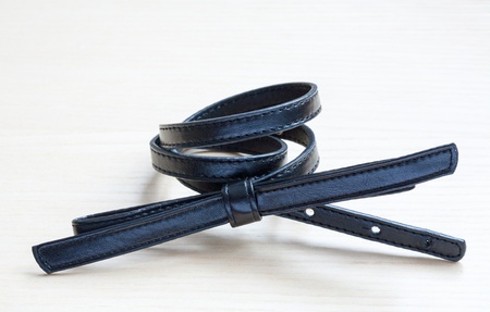 object on wooden background - waist-belt close upの写真素材