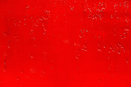 abstract background of old red paint on the metal surfaceの写真素材