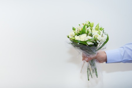wedding bouquet in a hand of the groom on white background.の写真素材