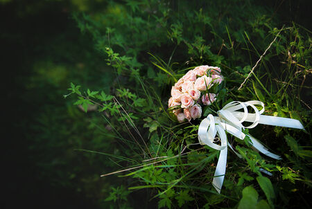 beautiful wedding pink flowers bouquet on the green grass.の写真素材