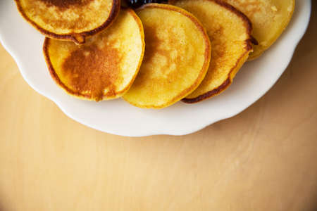 Fried pancakes on old wooden table. Top view and darkened cornersの写真素材