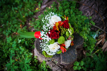 beautiful wedding bouquet lying on green grassの写真素材