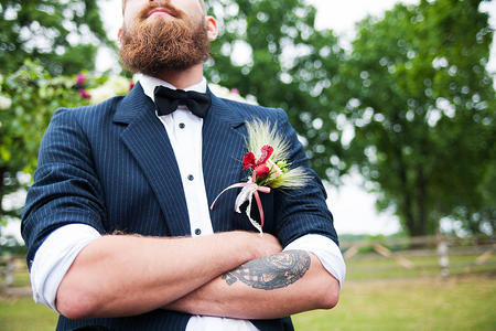 Groom in white shirt and bow tie his arms folded.の写真素材