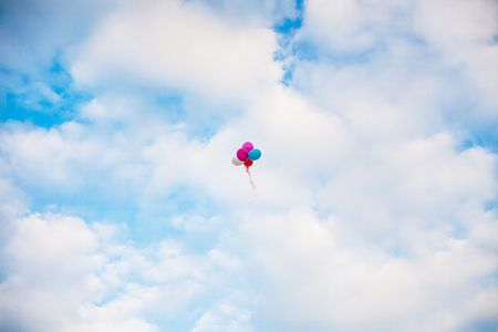 Bunch of colorful balloons in blue sky.の写真素材