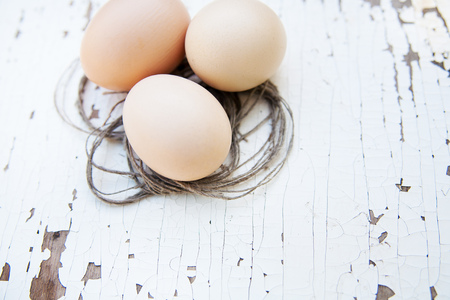 eggs lie on an old white table.の写真素材
