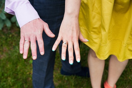 Closeup view of married couple holding hands.の写真素材